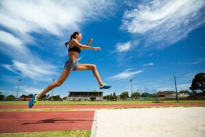Female athlete landing from a jump during sports activity