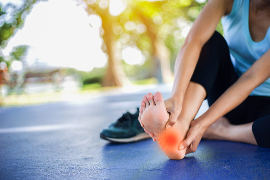Person experiencing sudden foot pain without injury during exercise.