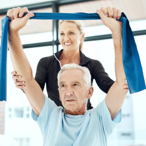Physical therapist providing encouragement during a session for Physical Therapy Month.