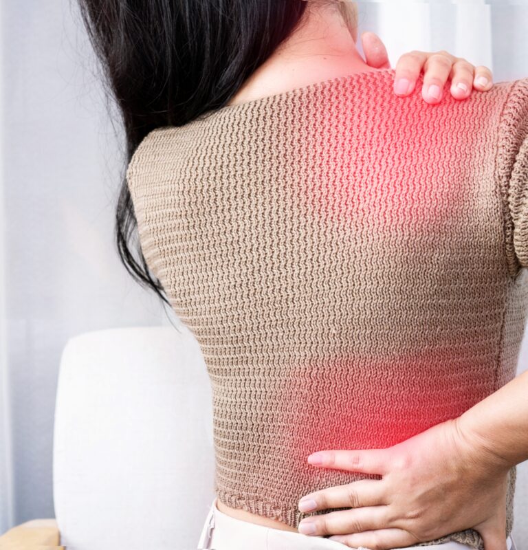 Woman experiencing shoulder and back pain spreading between areas, showing referred pain.