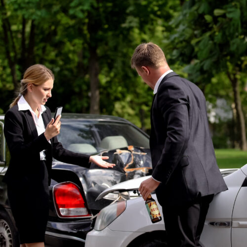 Driver calling police after a serious car accident in traffic, highlighting the aftermath of impaired driving
