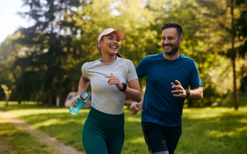Two people exercising together outdoors on National Exercise Day highlighting low impact exercise and staying active