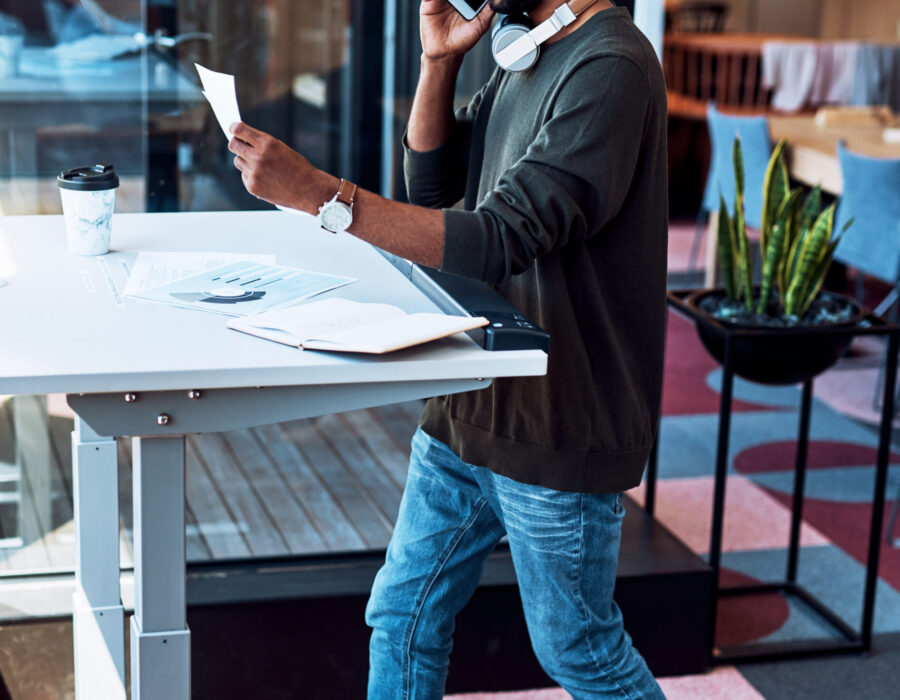 Remote worker using a walking pad and standing desk while working from home
