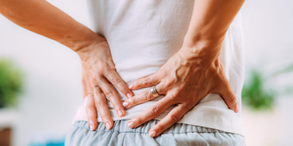 Patient experiencing lower back pain while seeking injury treatment in Suffolk County