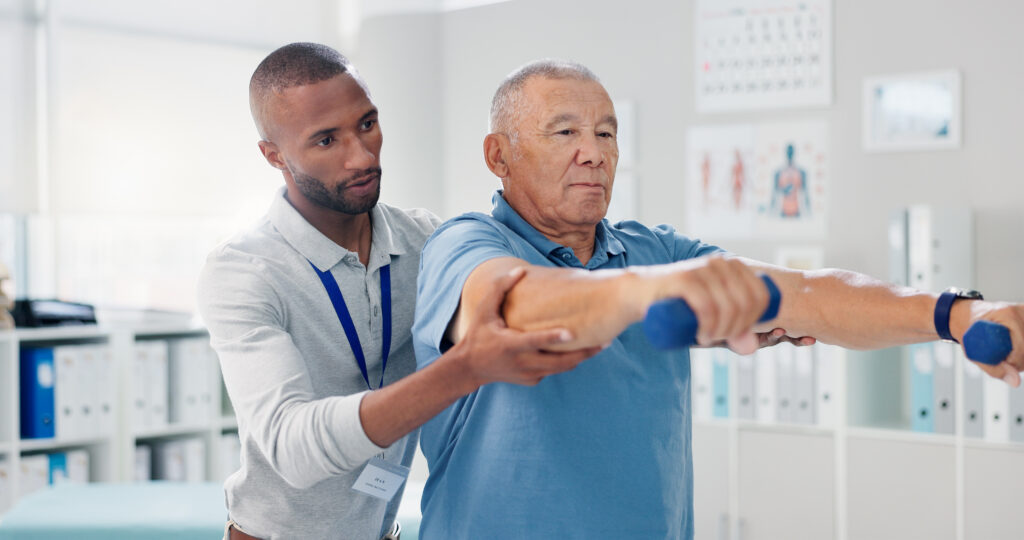 Physical therapist assisting a patient during injury recovery treatment in Suffolk County