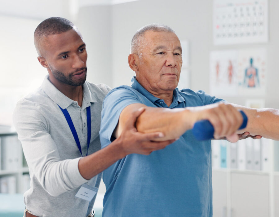 Physical therapist assisting a patient during injury recovery treatment in Suffolk County