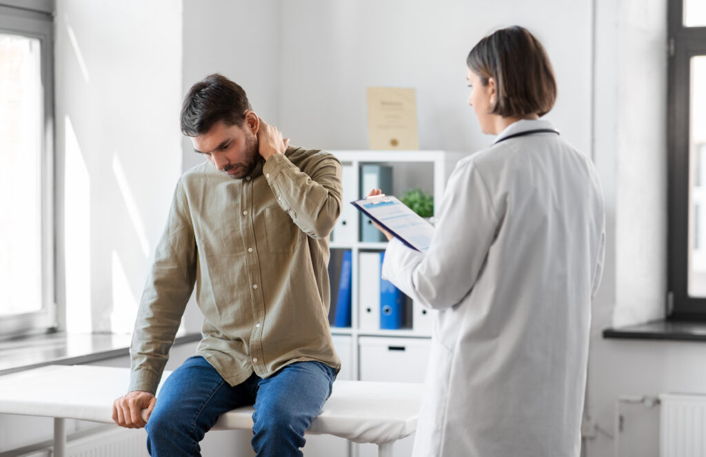 Discussing Recovery Concerns After a Car Accident Healthcare provider speaking with a patient recovering from injuries after a car accident