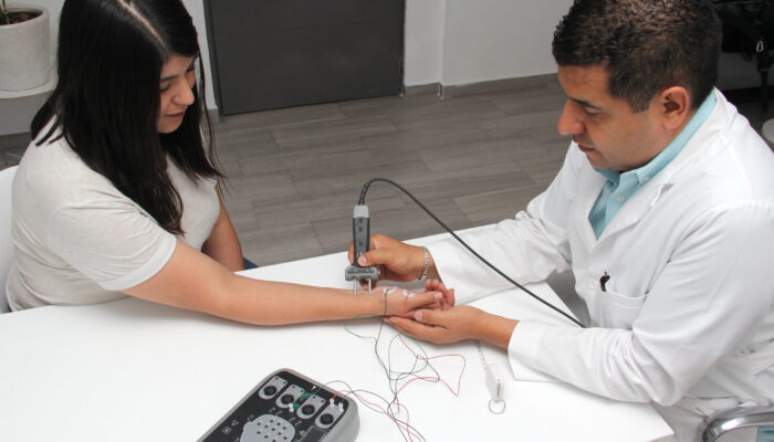 EMG Testing for Upper Extremity Nerve Symptoms Healthcare provider performing an EMG test on a patient's arm to evaluate nerve and muscle function after injury