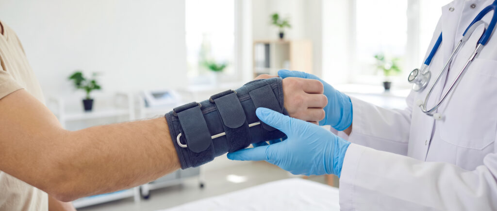Physical Therapy for Soft Tissue Injuries Physical therapist assisting patient recovering from a wrist injury.