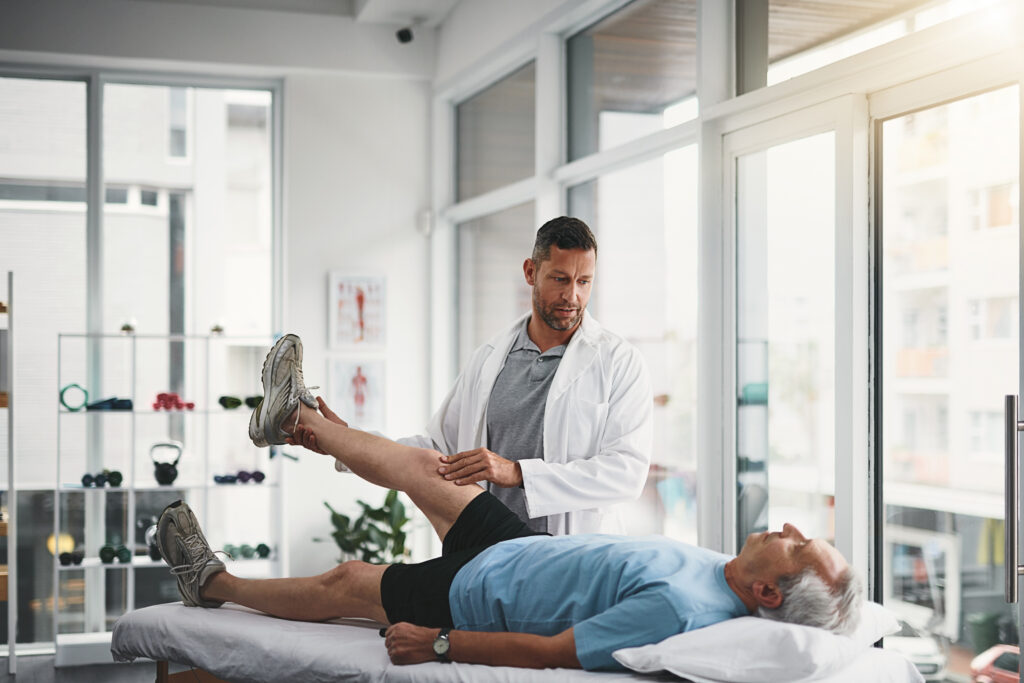 Recovery Following Knee Surgery Patient performing rehabilitation exercises with a knee brace after surgery.