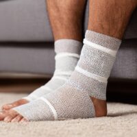 Athlete wearing an ankle brace while recovering from a musculoskeletal injury.