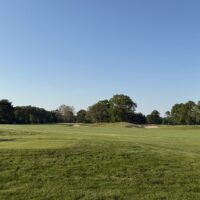 Golfers teeing off at a Long Island golf course during golf season