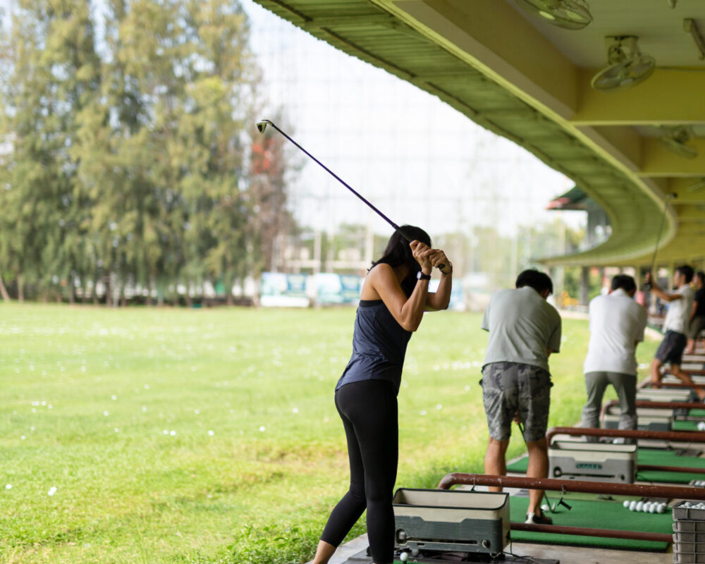 Golfer practicing swing mechanics at driving range on Long Island