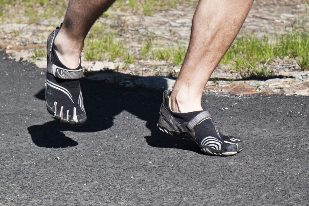 Person walking in barefoot shoes during a barefoot shoes transition
