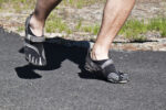 Person walking in barefoot shoes during a barefoot shoes transition