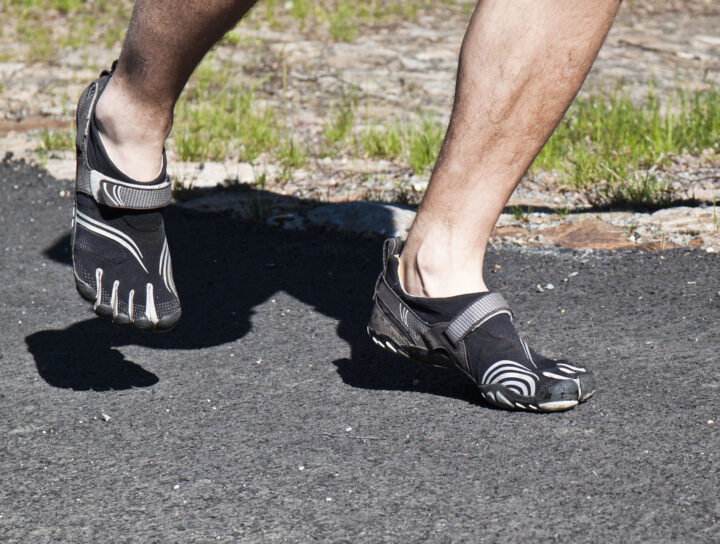 Person walking in barefoot shoes during a barefoot shoes transition