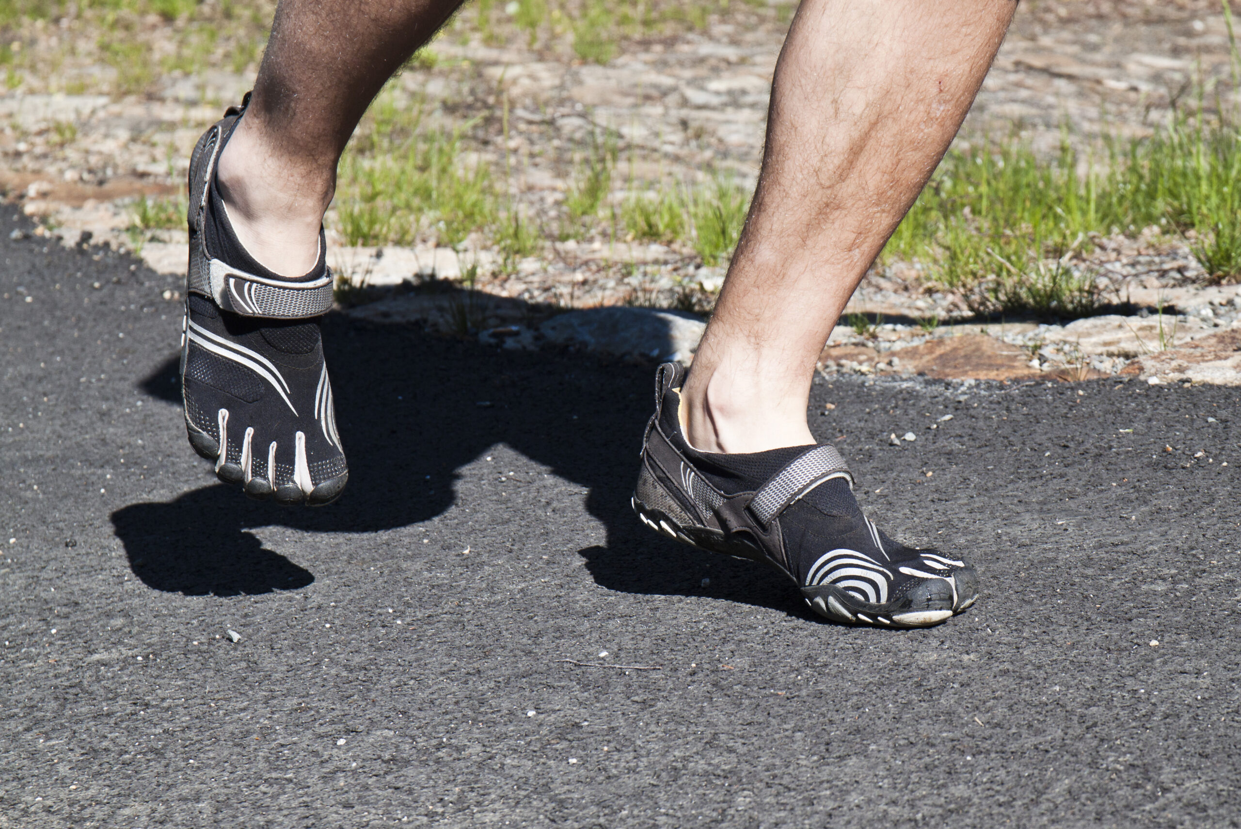 Person walking in barefoot shoes during a barefoot shoes transition