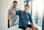 Physical therapist assessing shoulder movement during rehabilitation after an injury following a treatment gap in physical therapy.